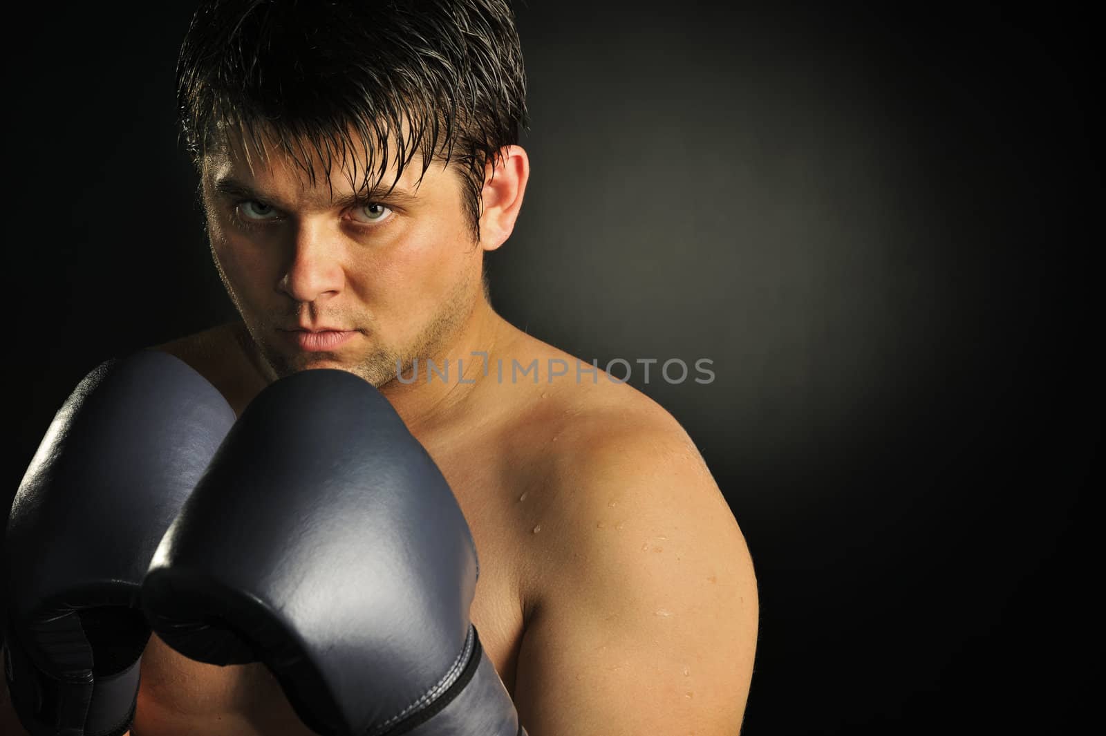 The boxer. The young man in boxing gloves