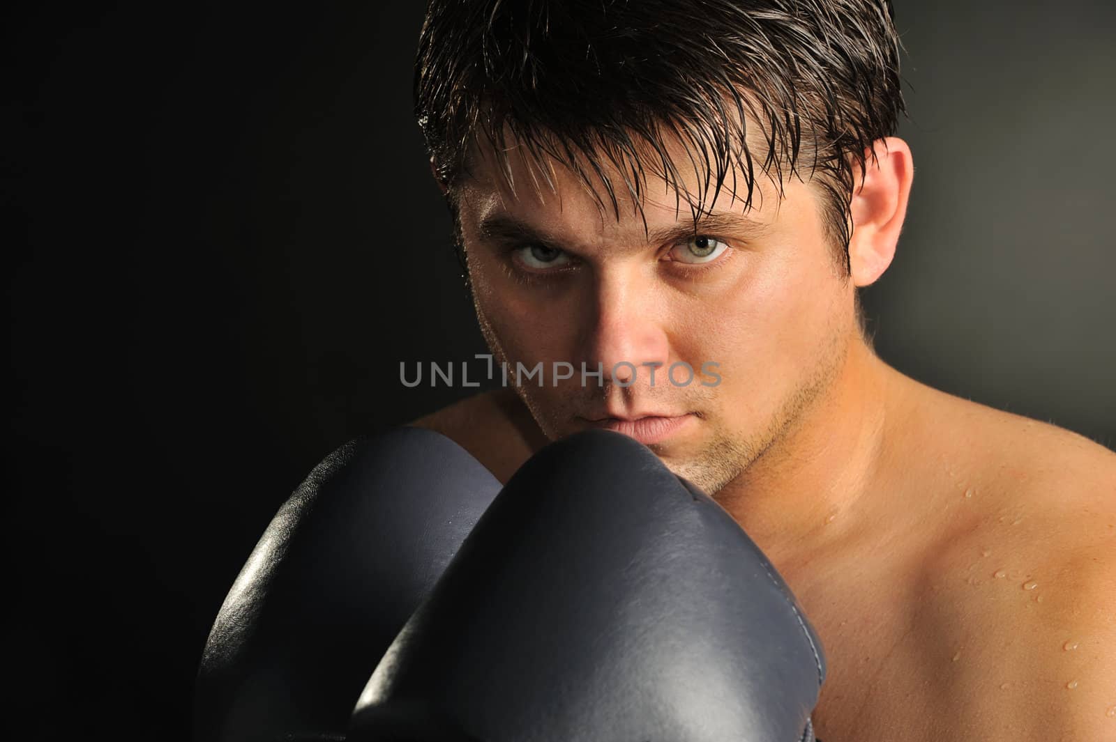 The boxer. The young man in boxing gloves
