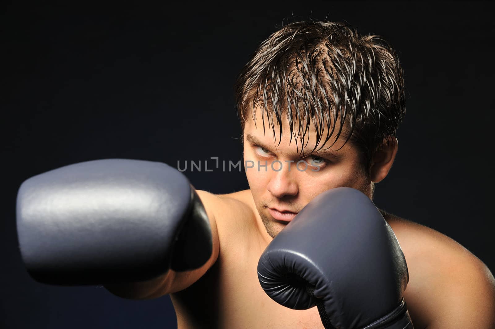 The boxer. The young man in boxing gloves