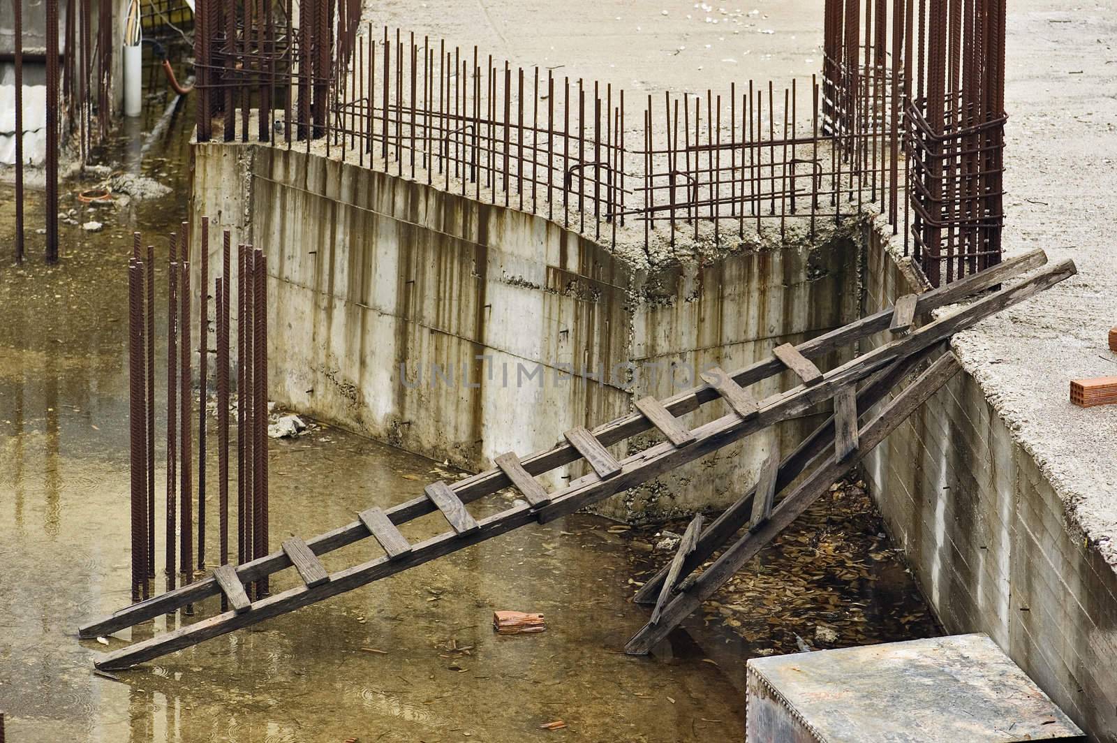 Rusty steel bars and ladders at construction site.