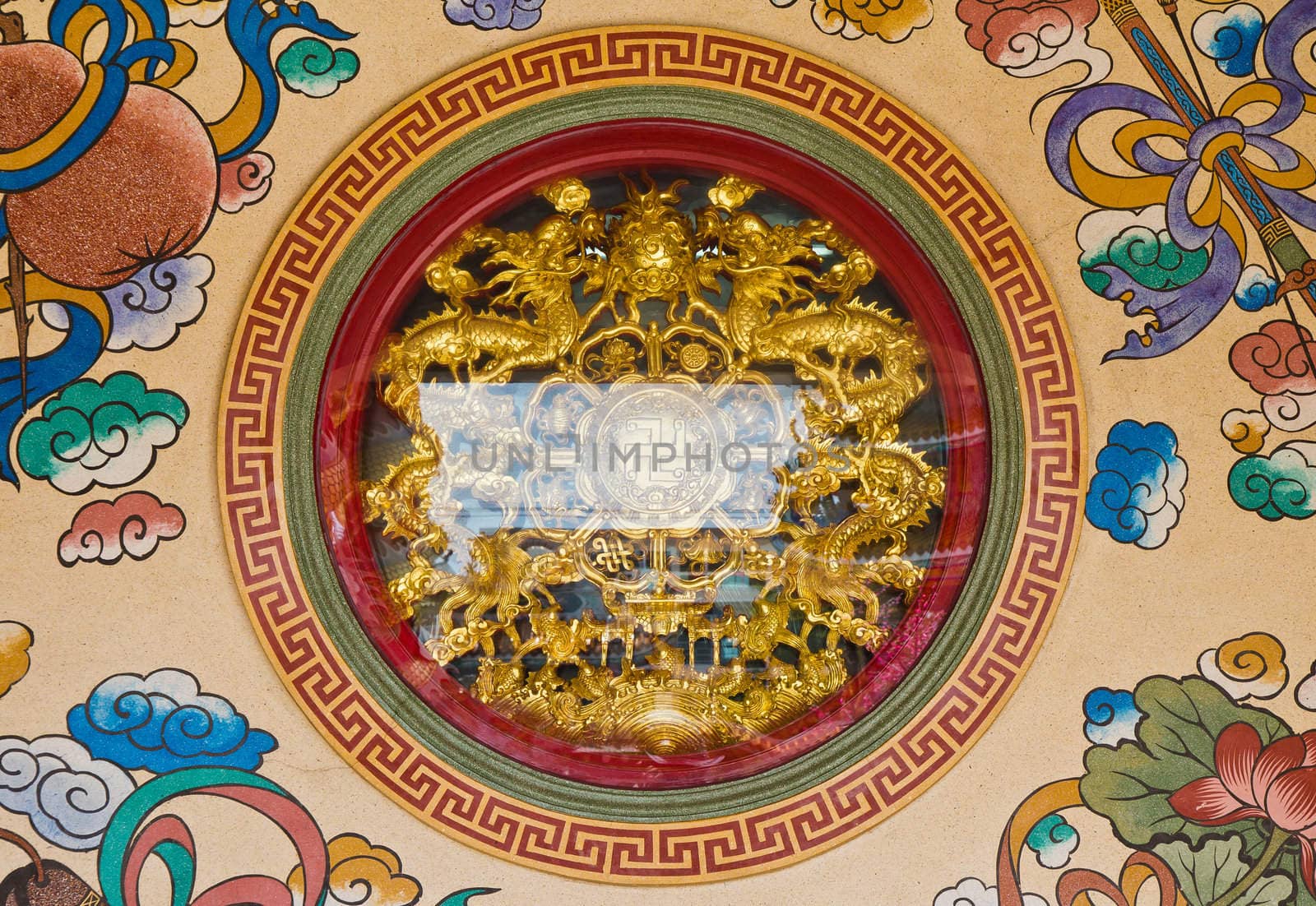 Golden dragon statue in the circle at the Chinese temple.