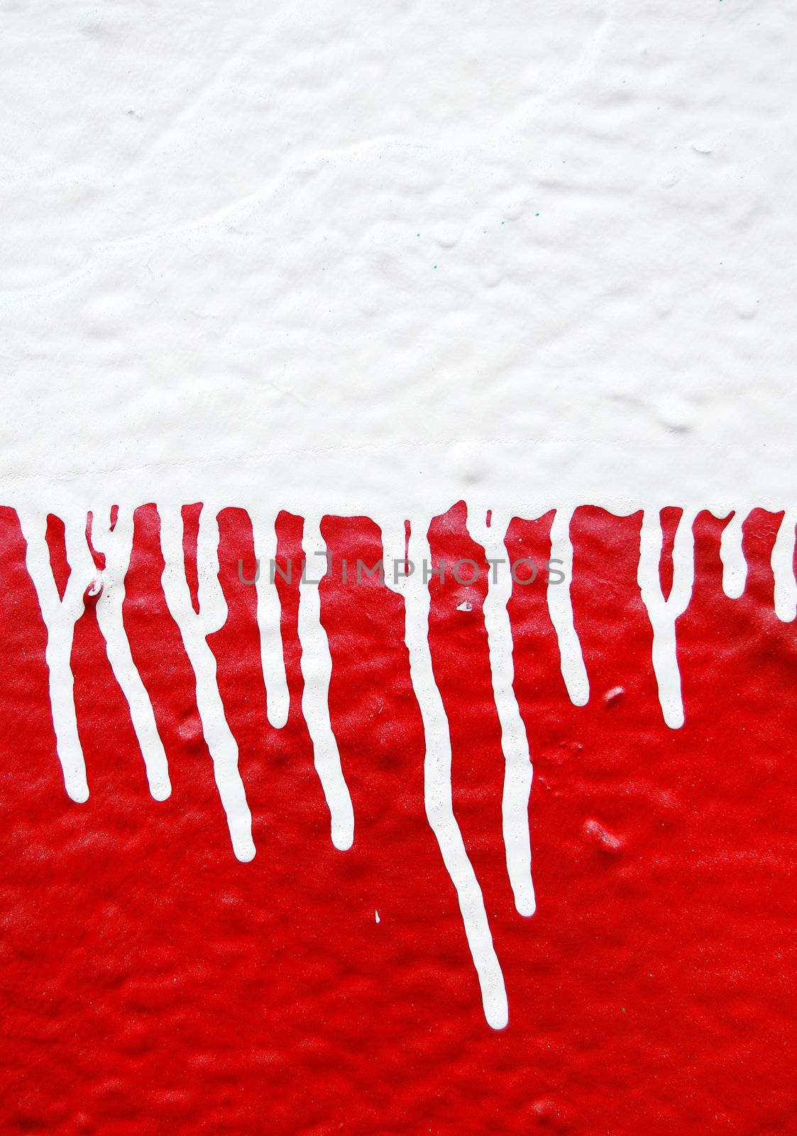 Wall with white dripping paint running over red background. Abstract texture.