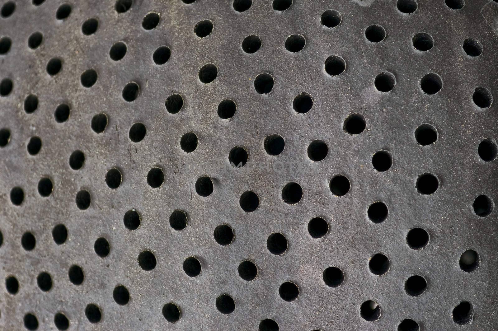 Holes pattern on ceramic surface. Abstract background.
