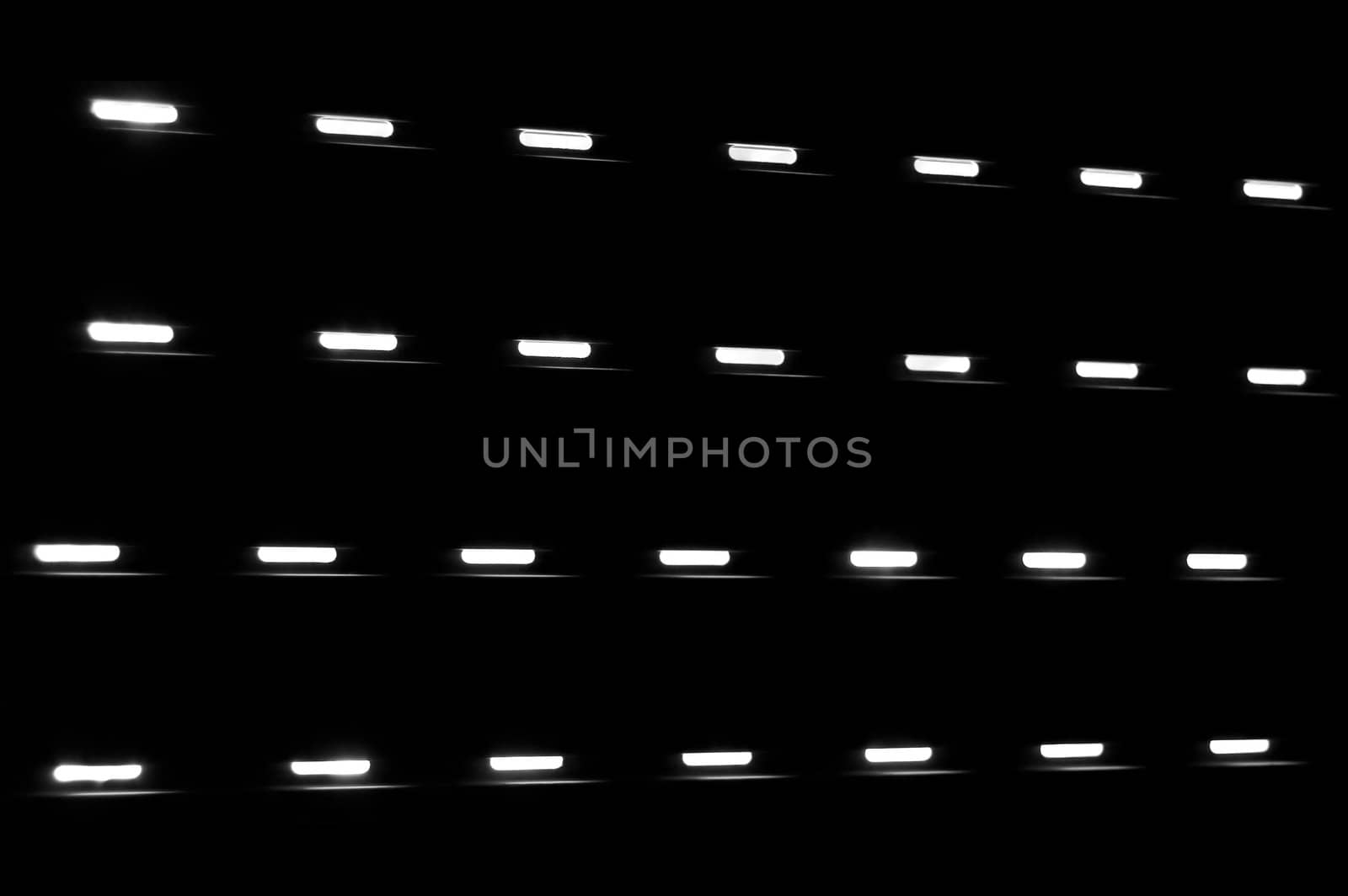 Dim light shining through a closed window shutter. Black and white.