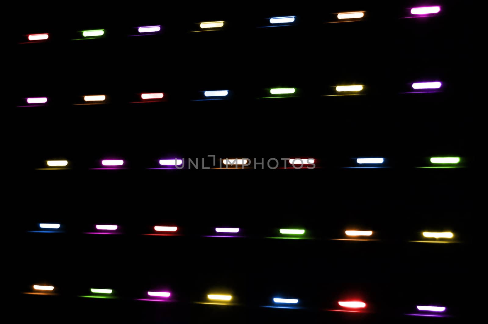 Colored lights shining through a window shutter. Abstract background.