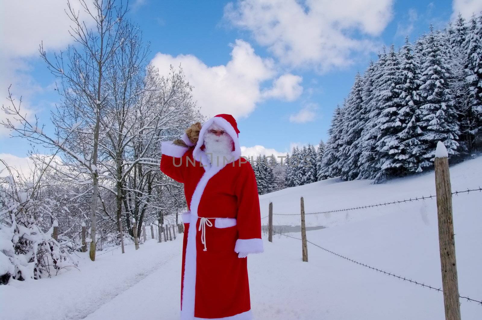 Santa Claus, Father Christmas in a beautiful winter landscape