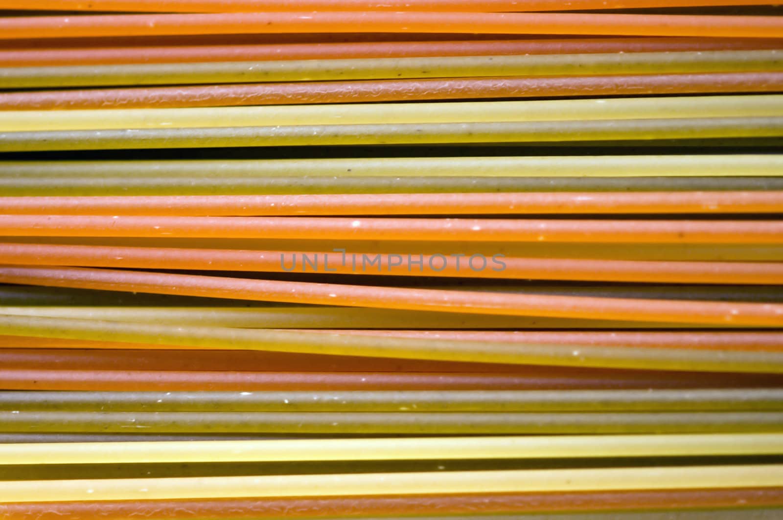 Multicolored spaghetti pasta texture. Abstract food background.