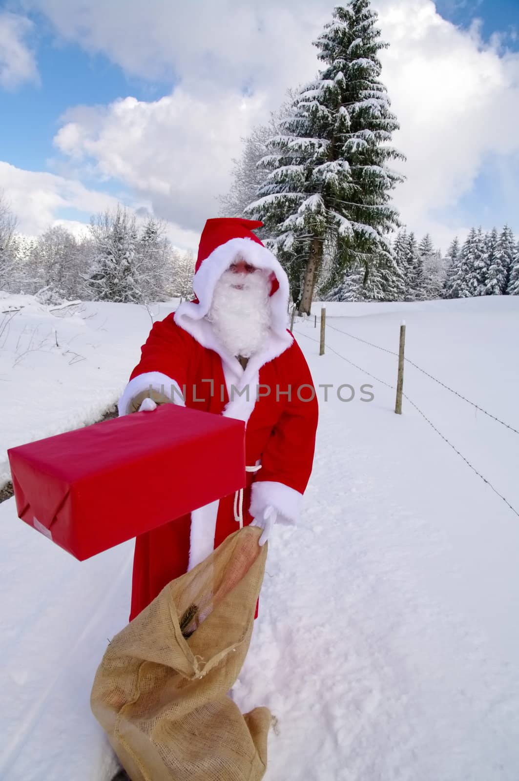 Santa Claus, Father Christmas holds red present