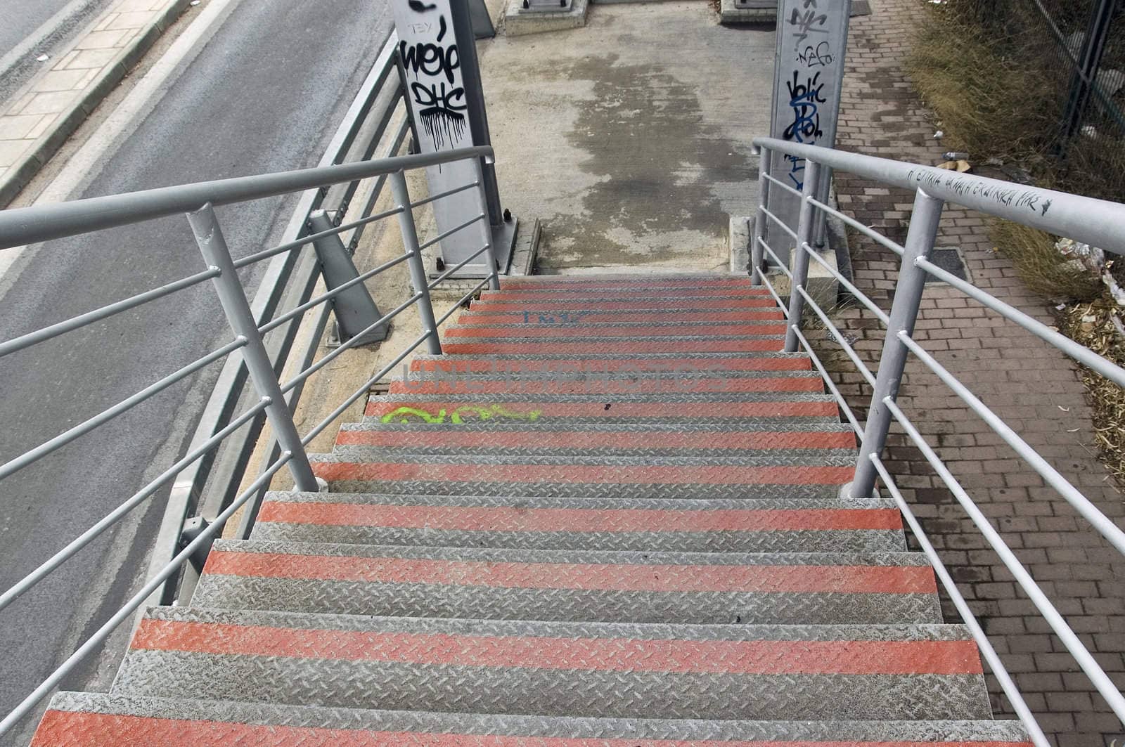 Metal stairs of pedestrian overpass bridge above the motorway.