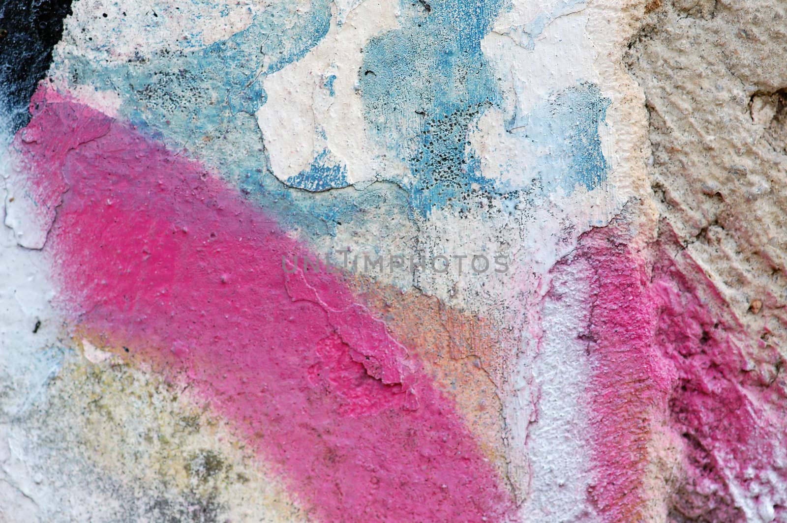 Paint stains on rough weathered wall surface.