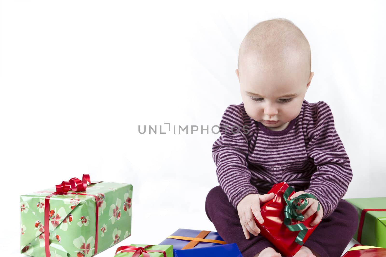 young child unpacking presents. white background