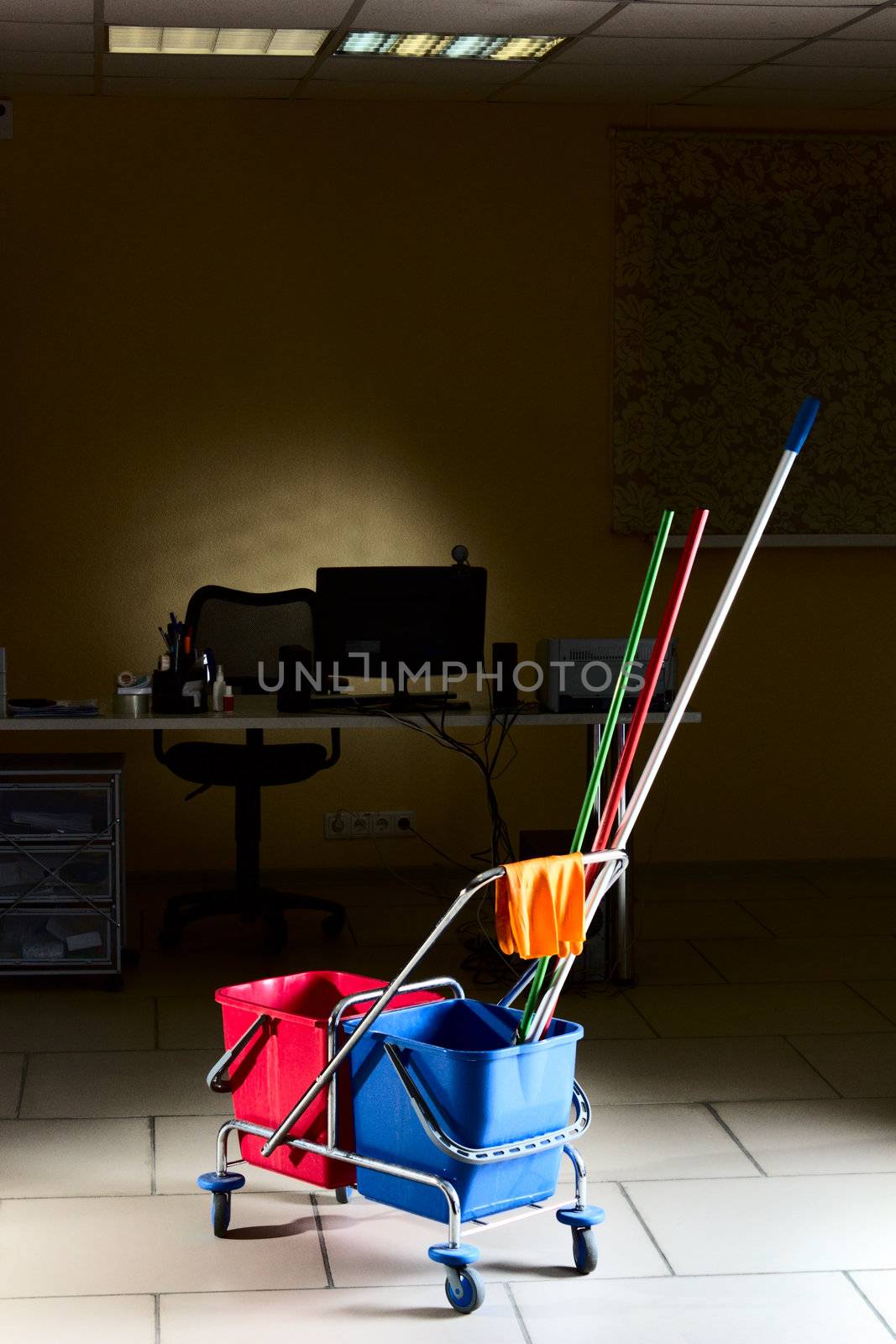 Trolley with water backets and cleaning stuff in the middle of the empty office