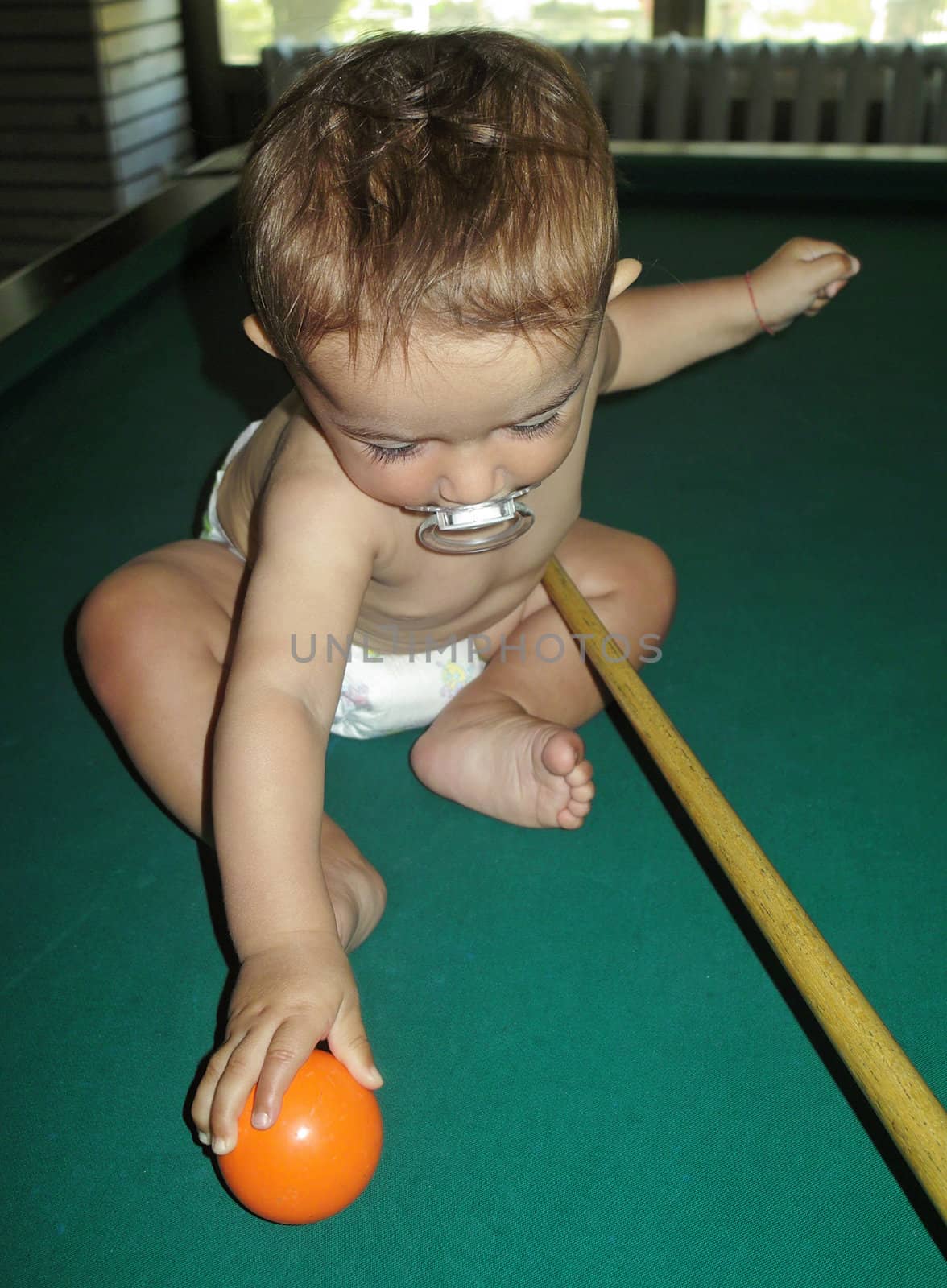 Little boy playing snooker by sattva