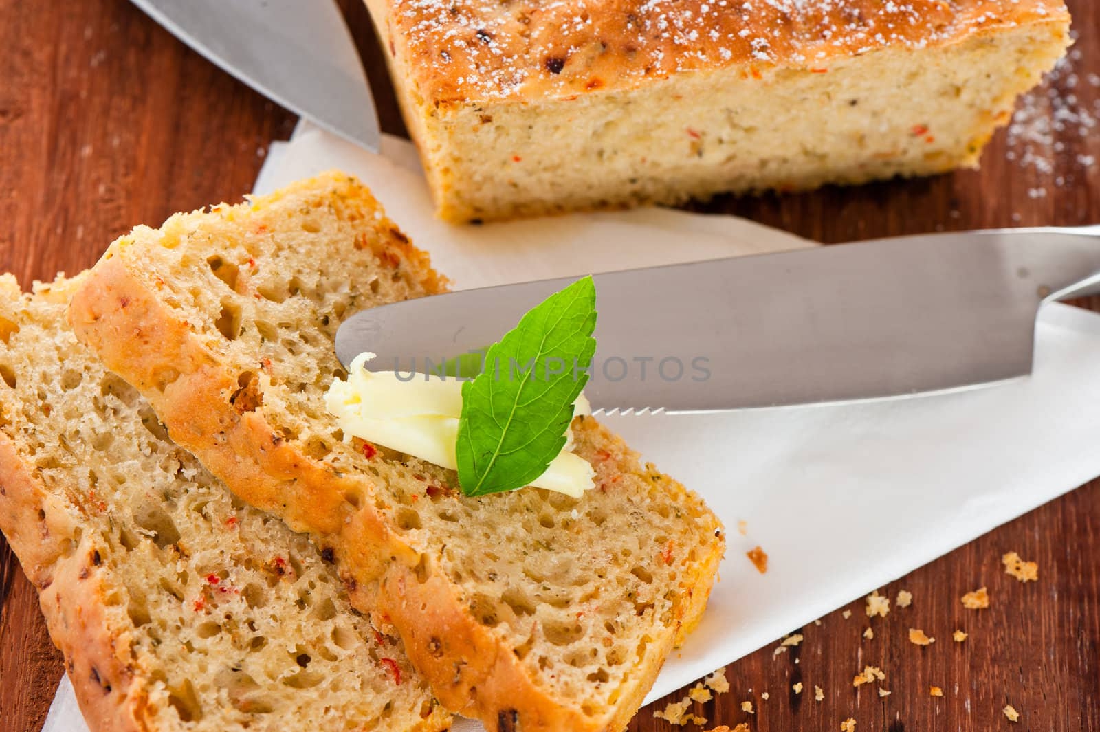 Homemade mediterranean bread with butter and a leaf of basil
