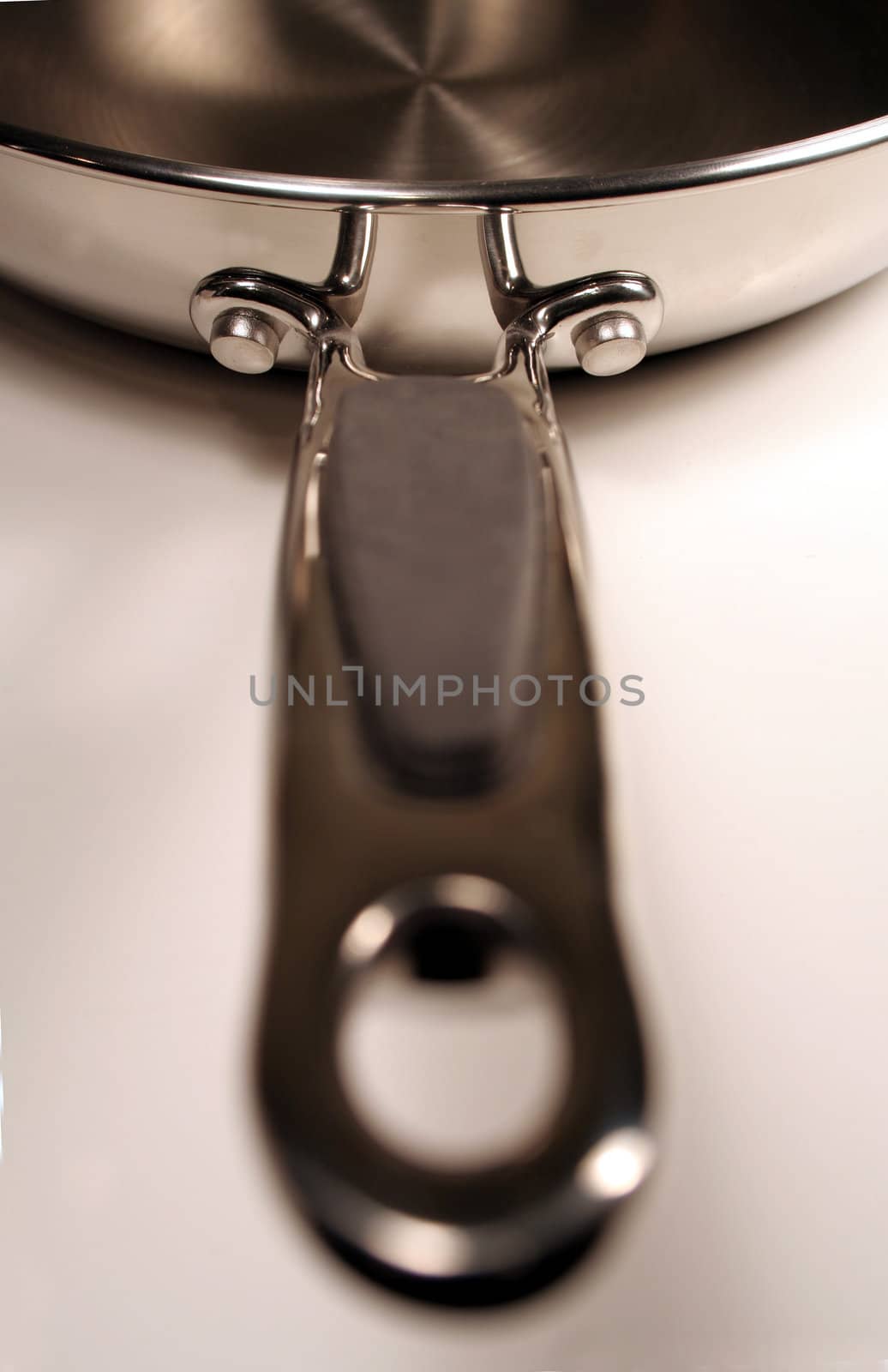 A stainless steel frying sitting with the handle facing out.
