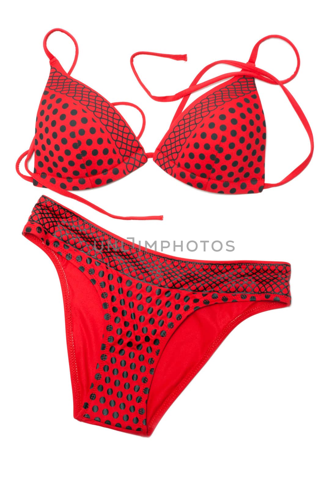 Red swimsuit in black polka dots on white background