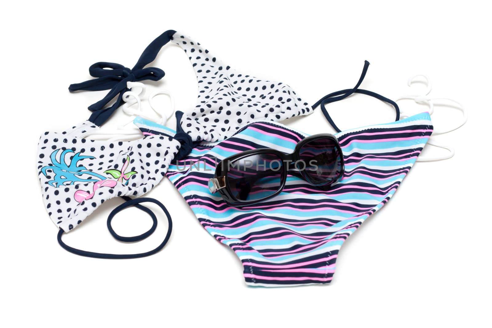 Sunglasses to rest upon striped swimsuit on white background