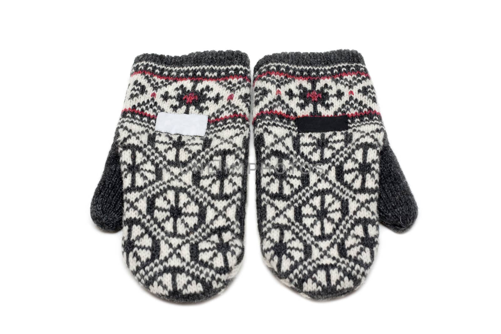 Knitted mittens on white background with pattern of the snowflake