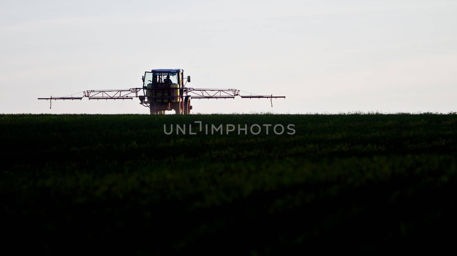 tractor spraying agricultural pesticide by gewoldi