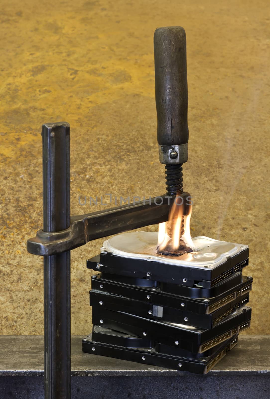 clamp pressing on burning stack of hard drives by gewoldi