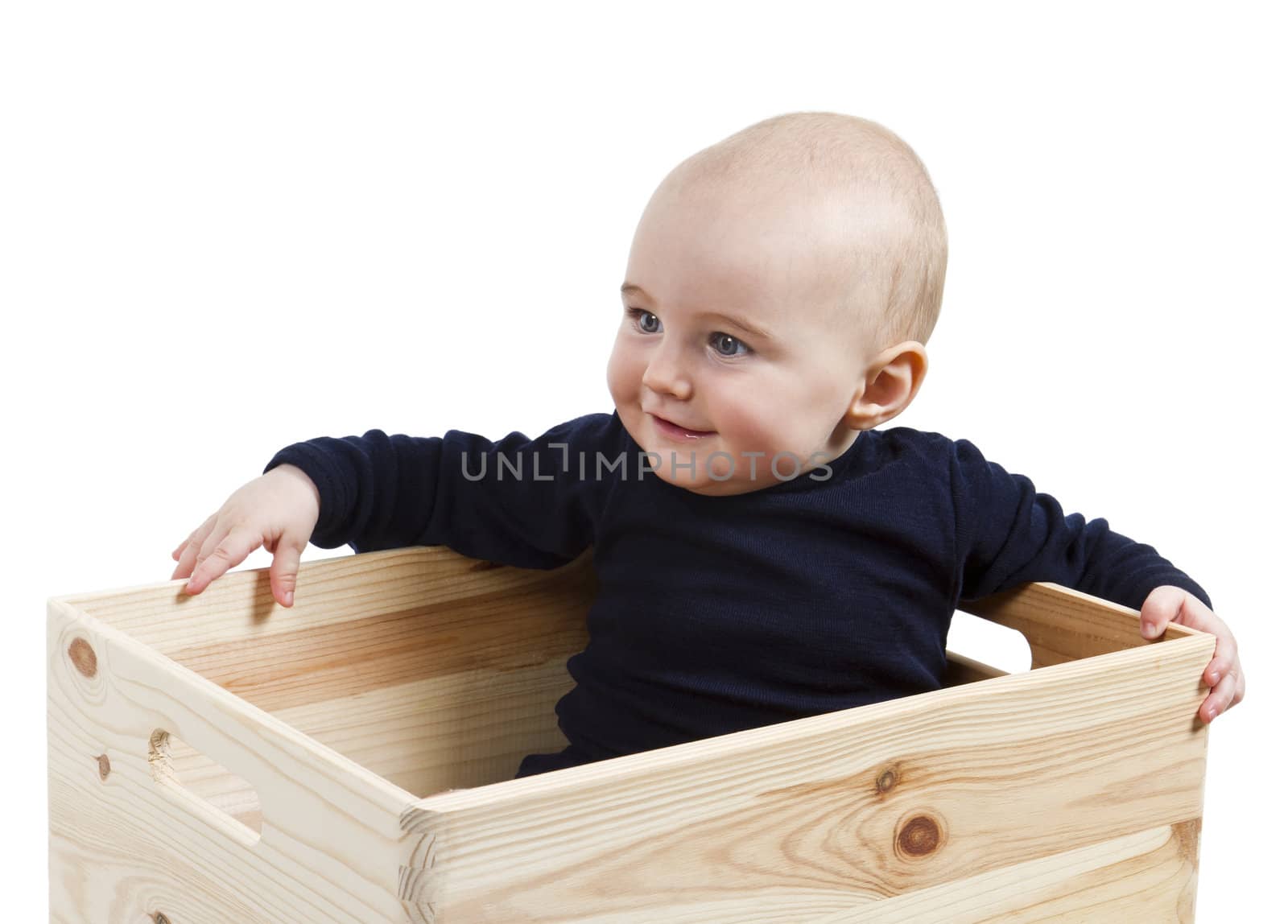 single toddler in wooden box looking to the left.