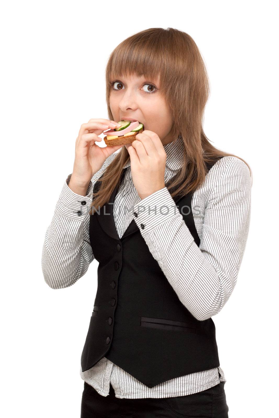 Young girl eats sandwich with sausage and cucumber