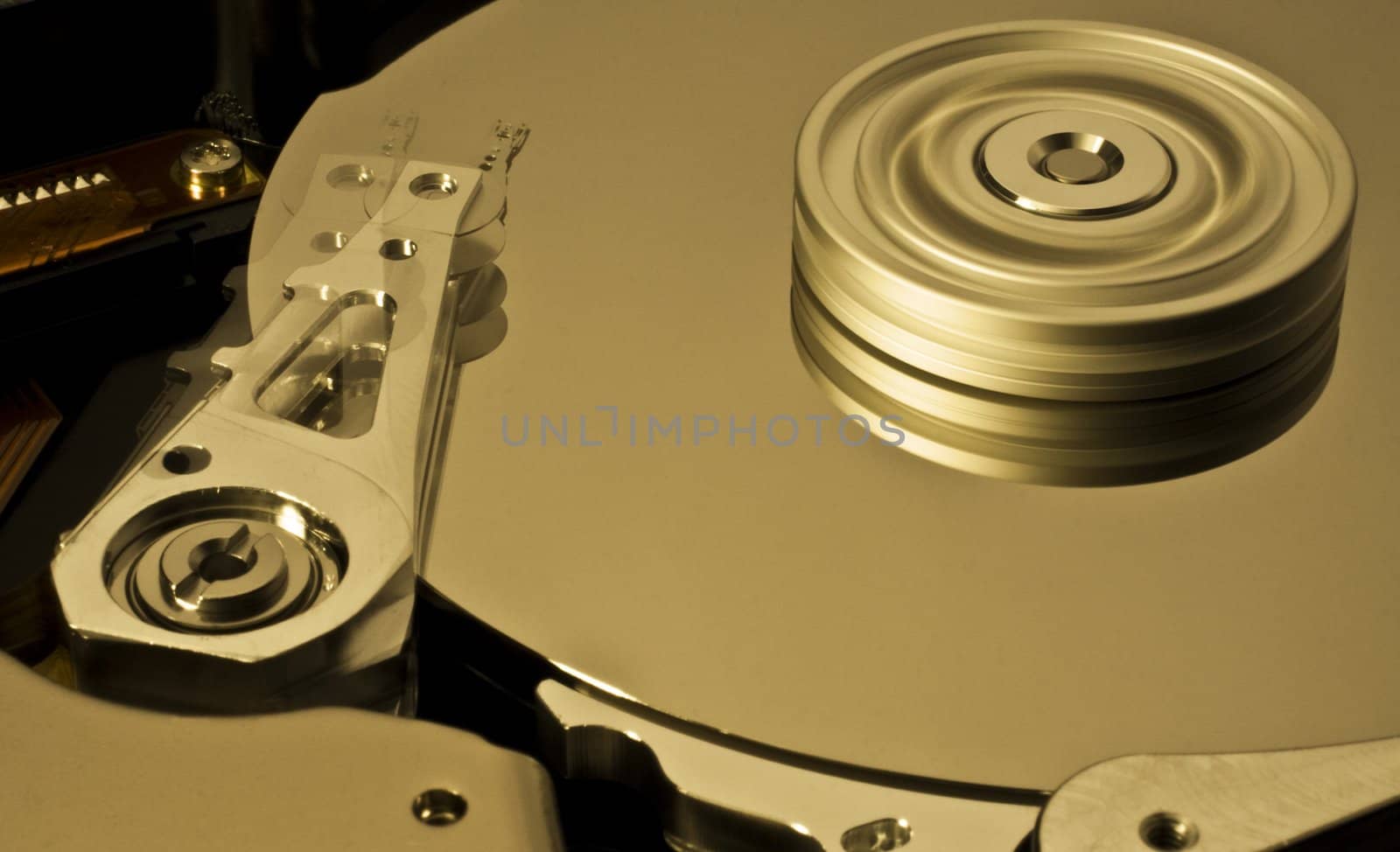Hard disk drive with moving head and spinning platter. Nice motion blur.