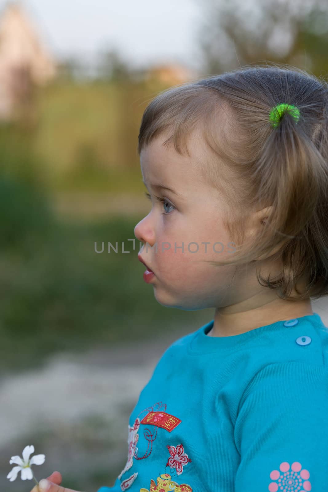 Little girl play with the flower in garden