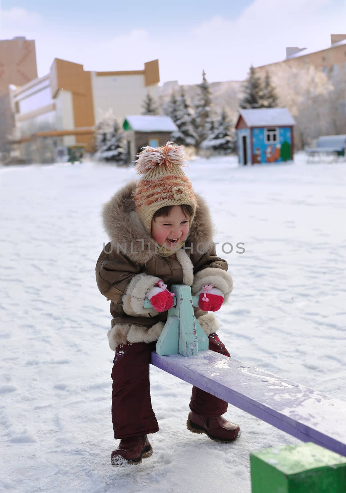 The girl on a swing. Winter, solar frosty weather