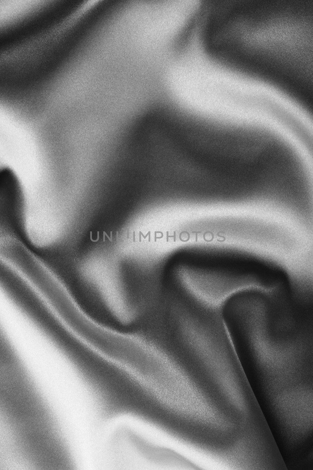 black satin background. A satiny fabric with beautiful light-shadow waves