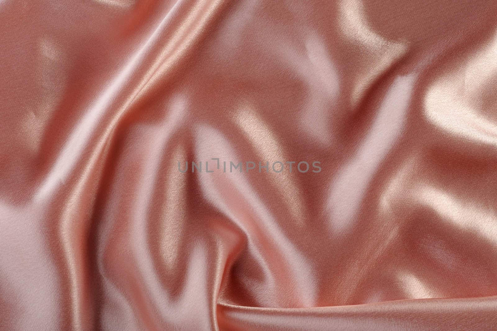 creamy satin background. A satiny fabric with beautiful light-shadow waves
