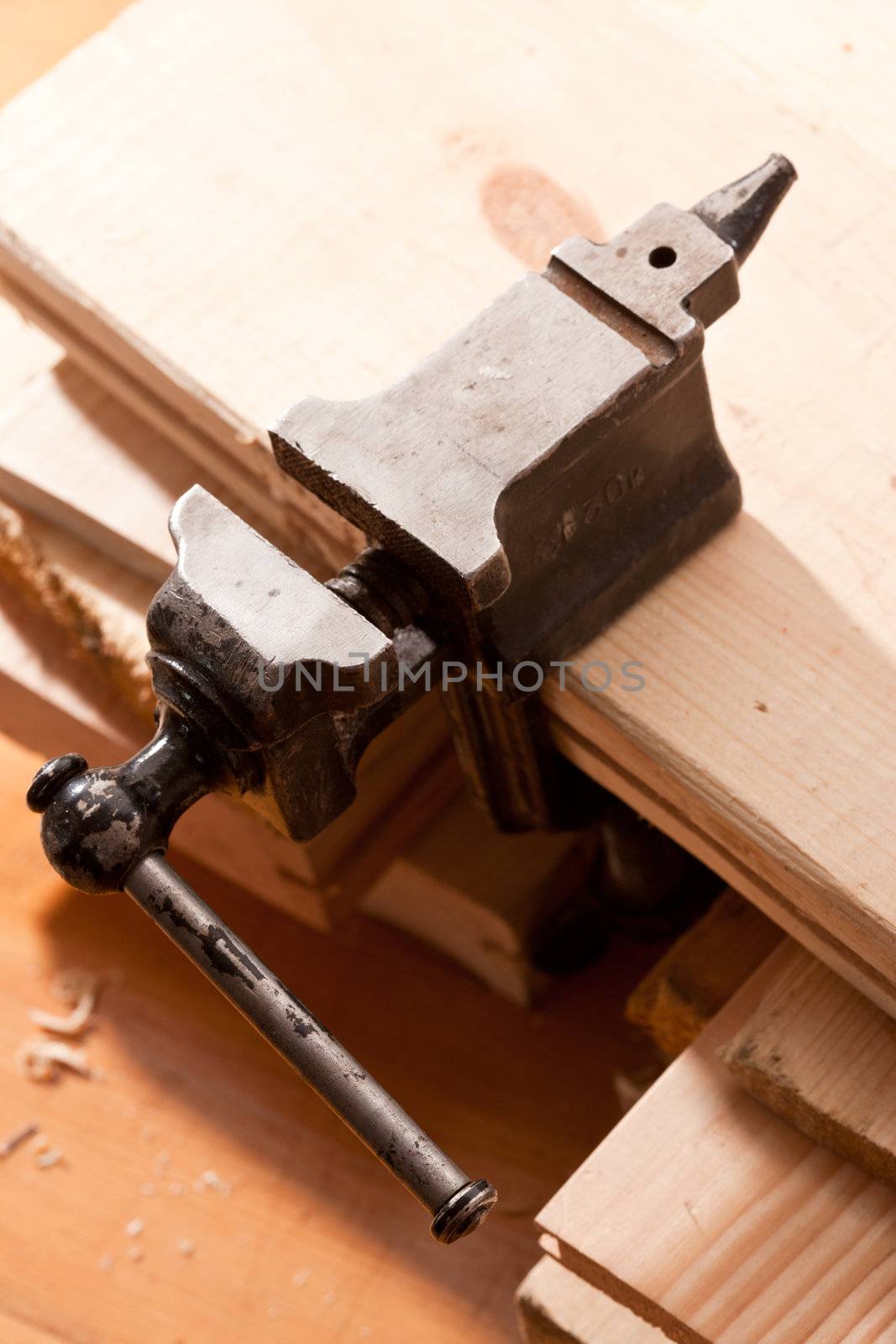 tools series: steel black grip vice on sawdust table