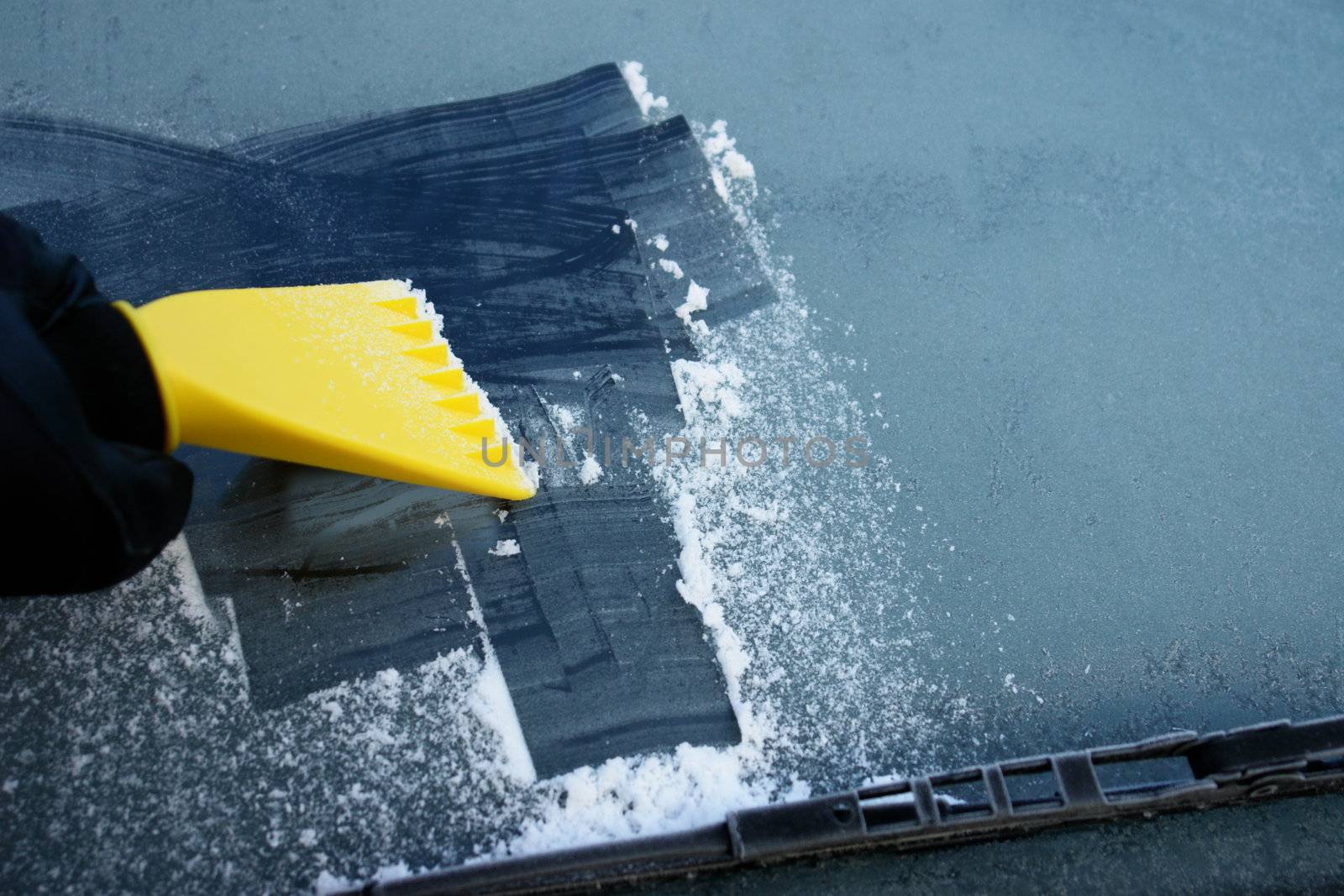 car windshield covered with ice and snow