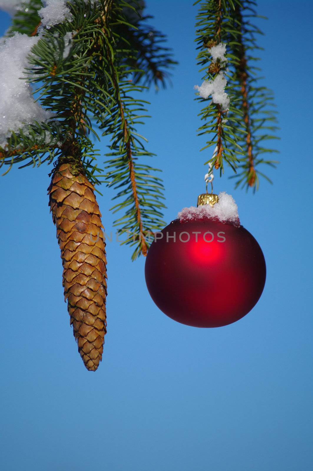 red bauble christmas ball ornament outside in a snowy winter scene