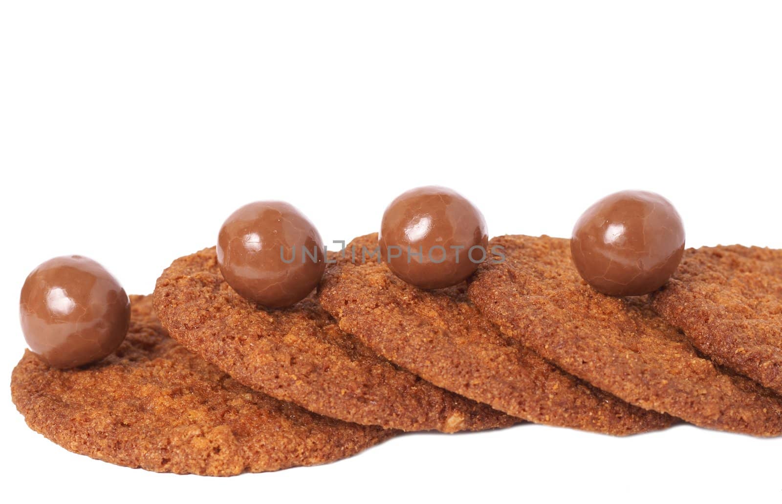 Macro shot of baked cookies and chocolate candy stacked together, shallow depth of field