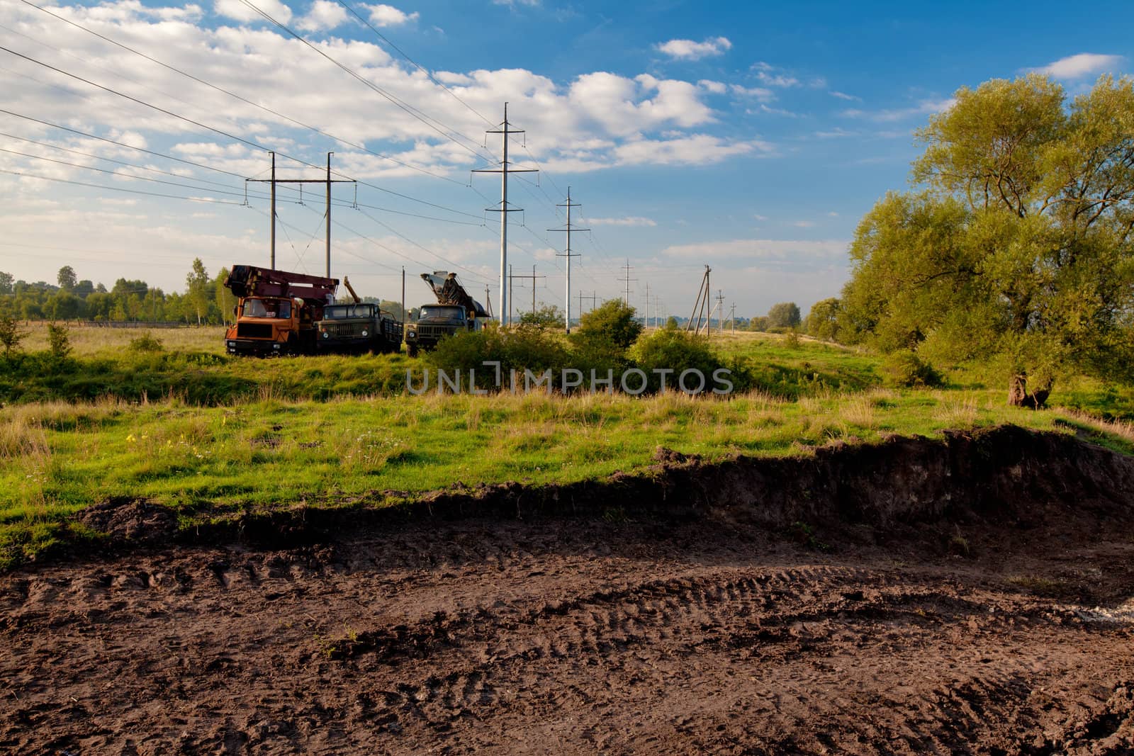 Construction machinery and power lines in the field