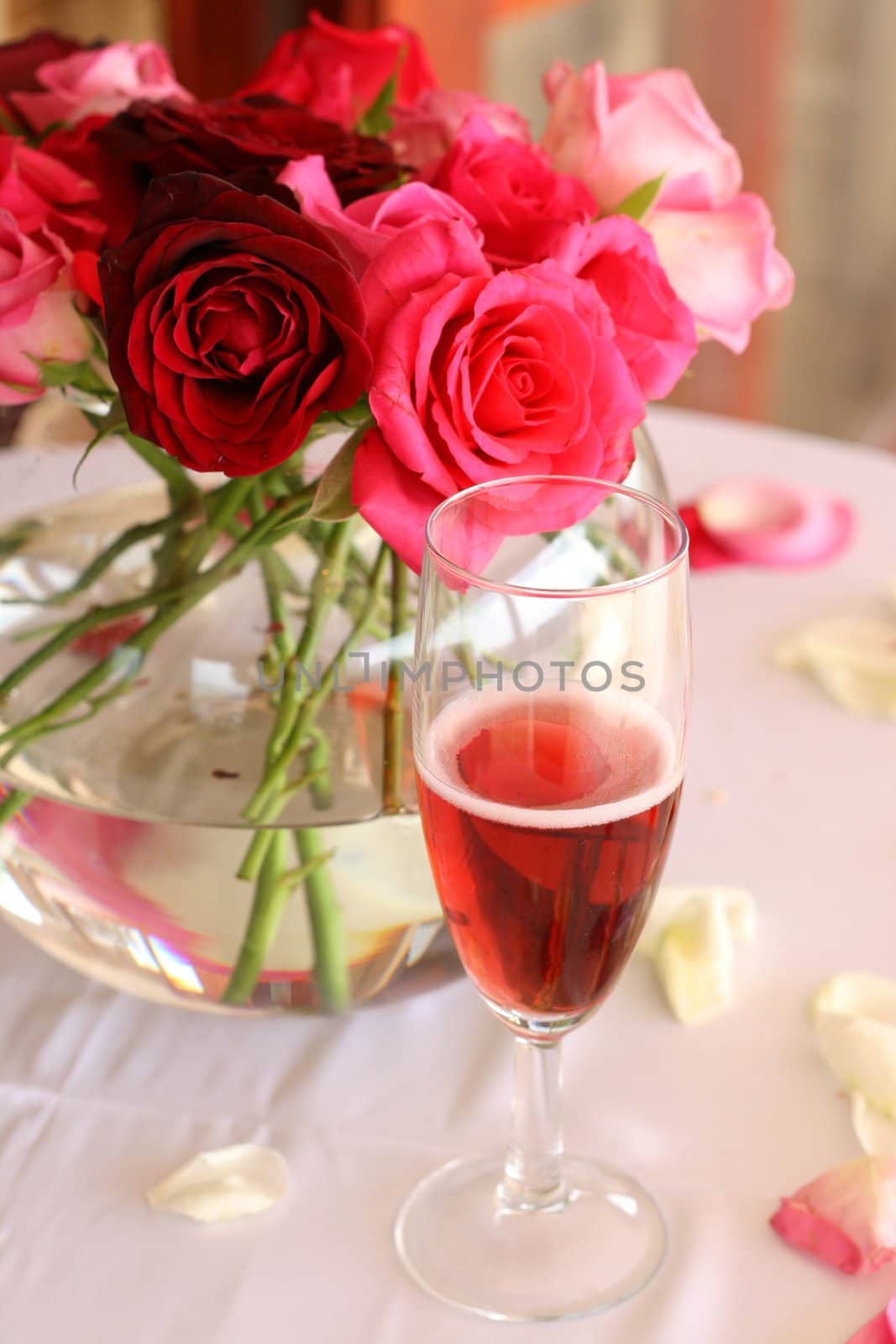 Bouquet of roses and glass of champagne at the wedding reception