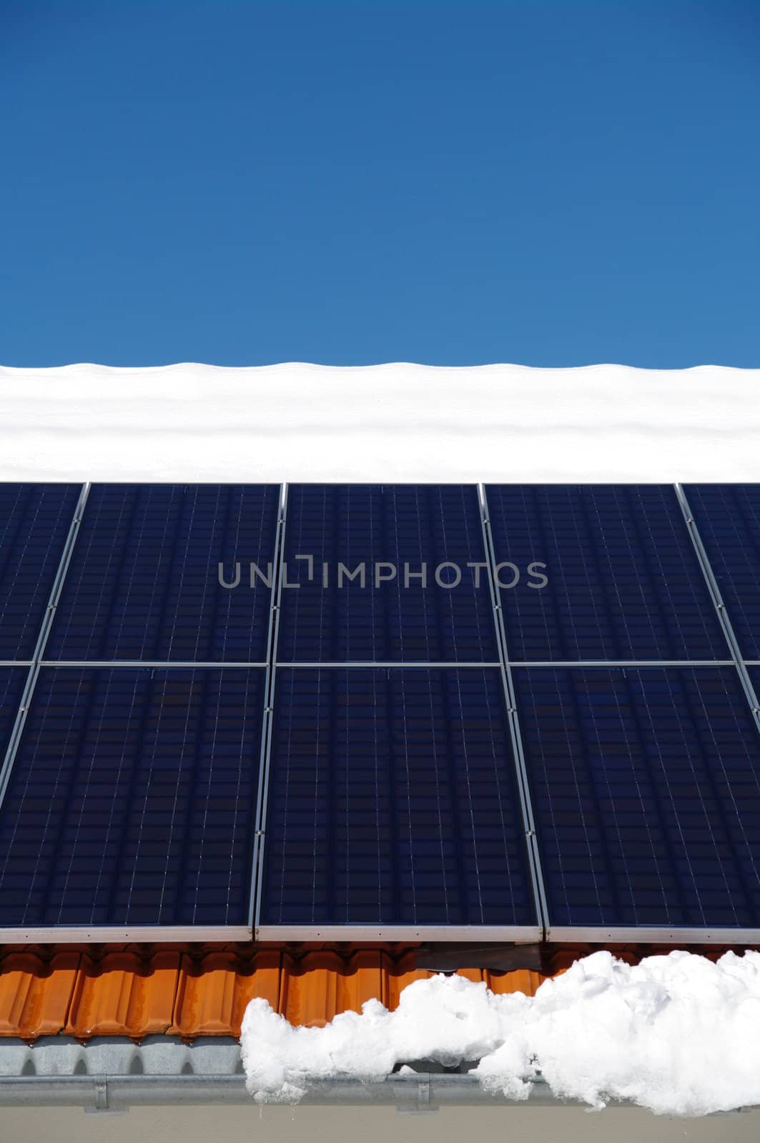 solarcells on a winter roof with snow...