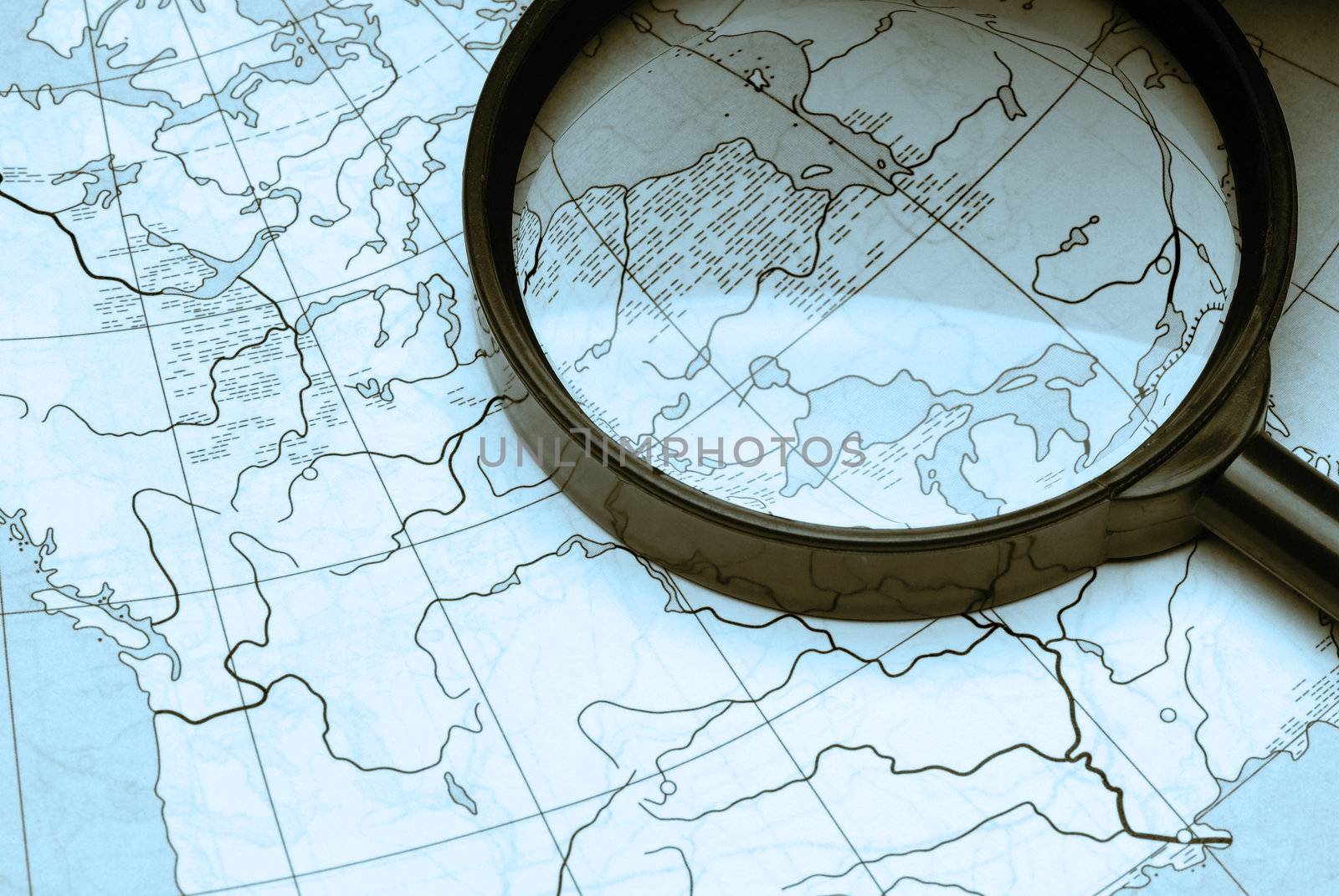 magnifier and card. Magnifying glass above a card of the world