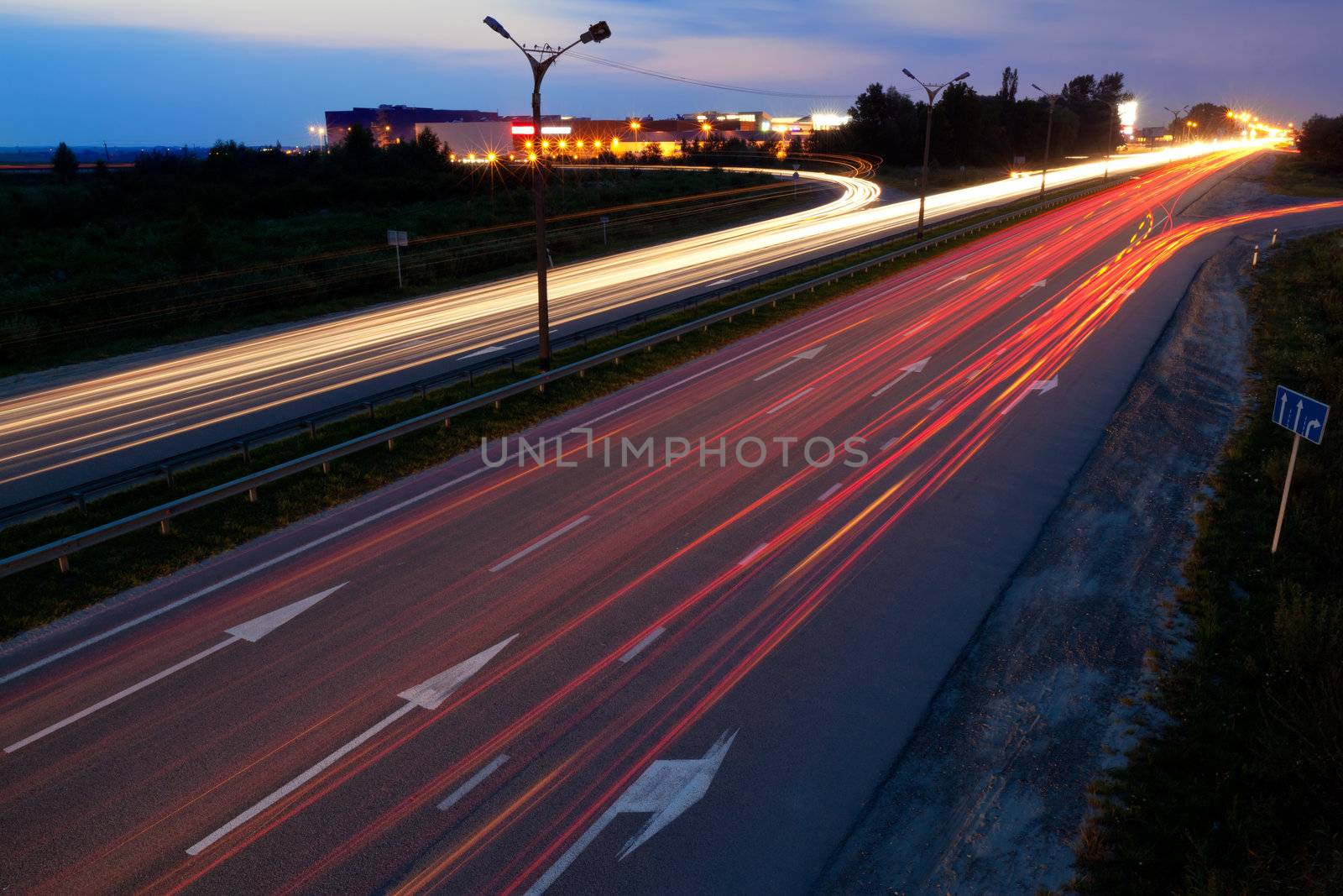 Light trails of evening highway. Urban background