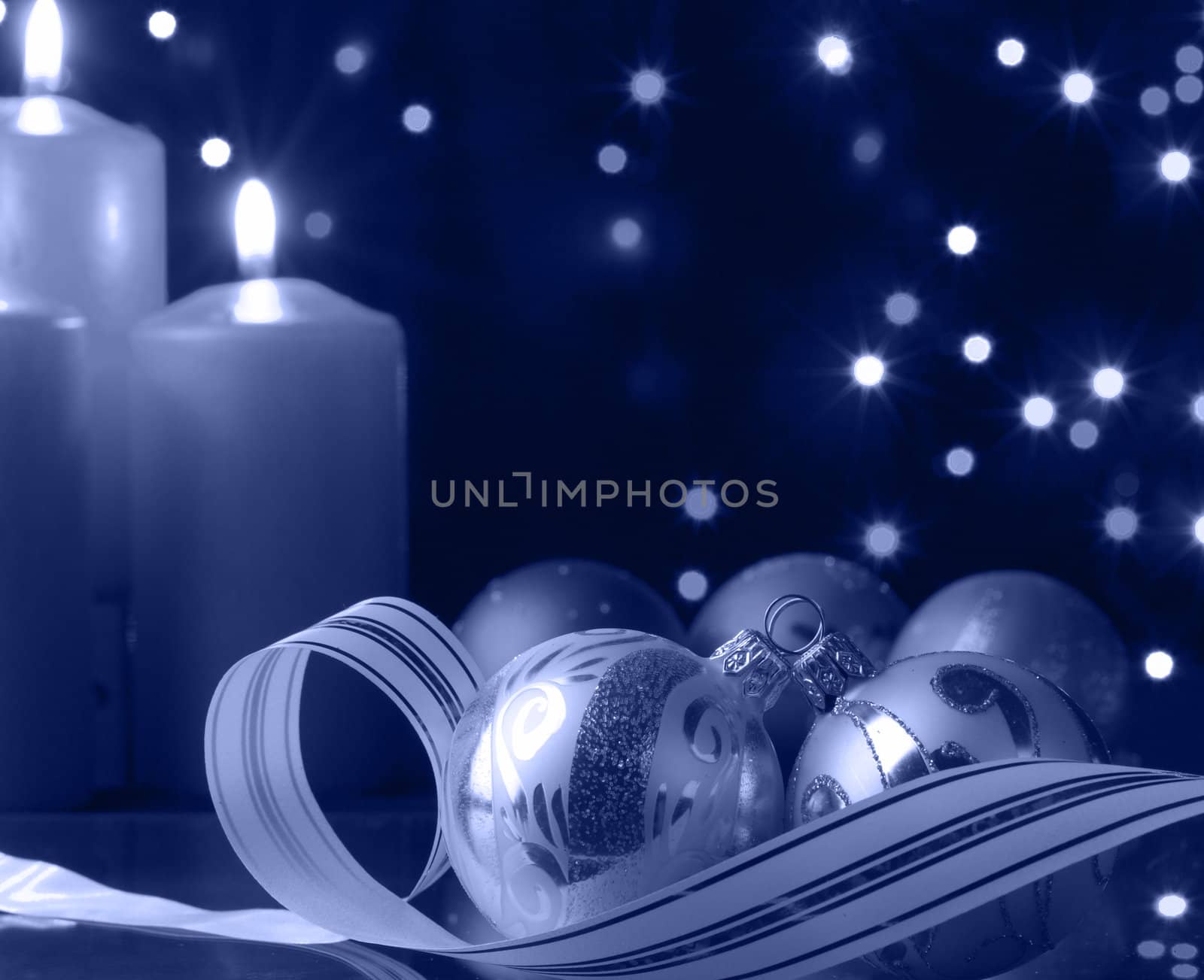 Christmas evening. A composition from candles, New Year's toys on a dark background