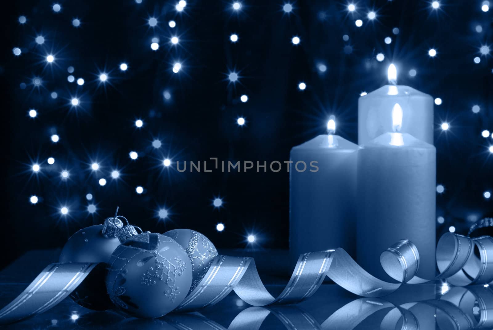 Christmas evening. A composition from candles, New Year's toys on a dark background