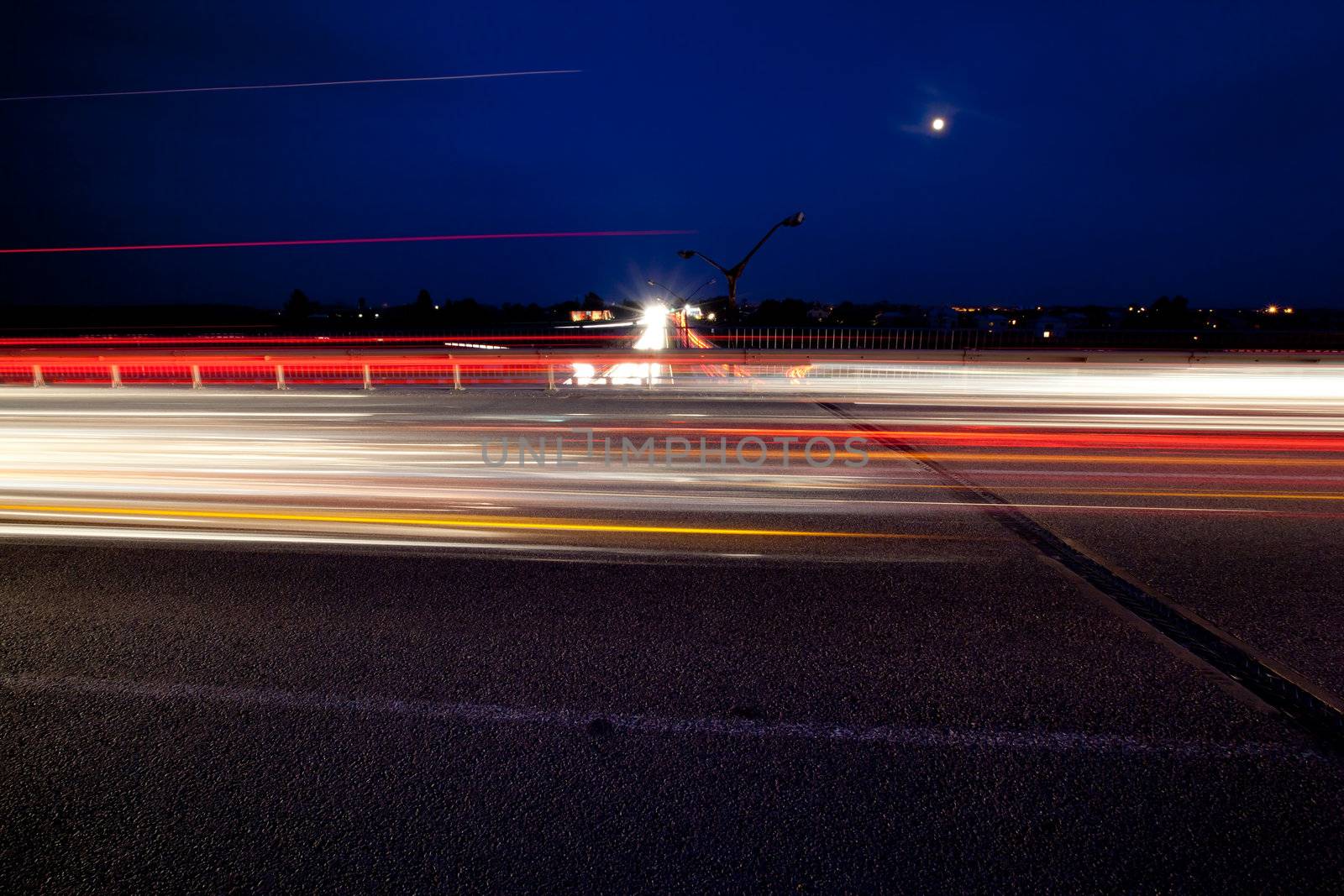 Light trails of evening highway. Urban background