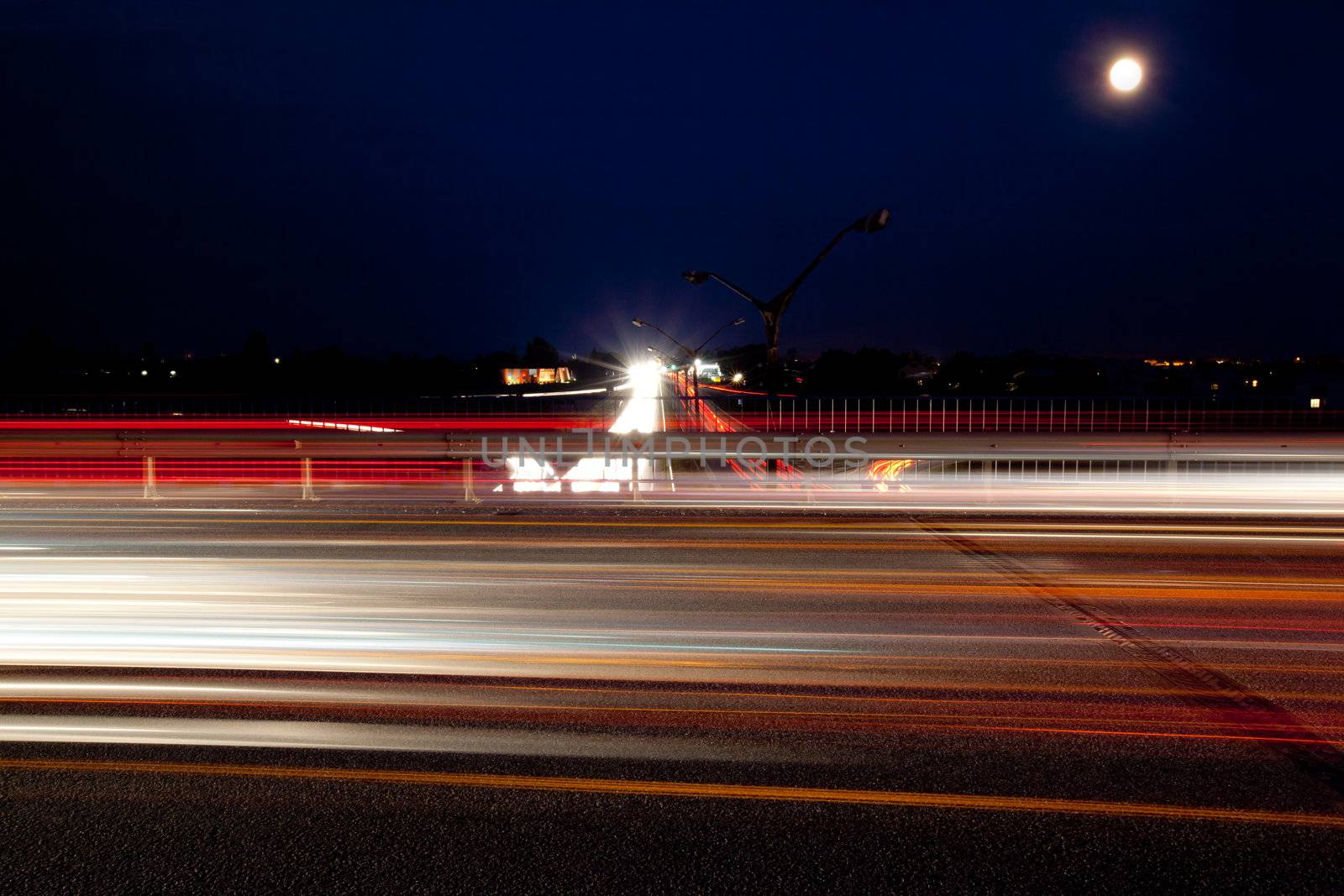 Light trails of evening highway. Urban background