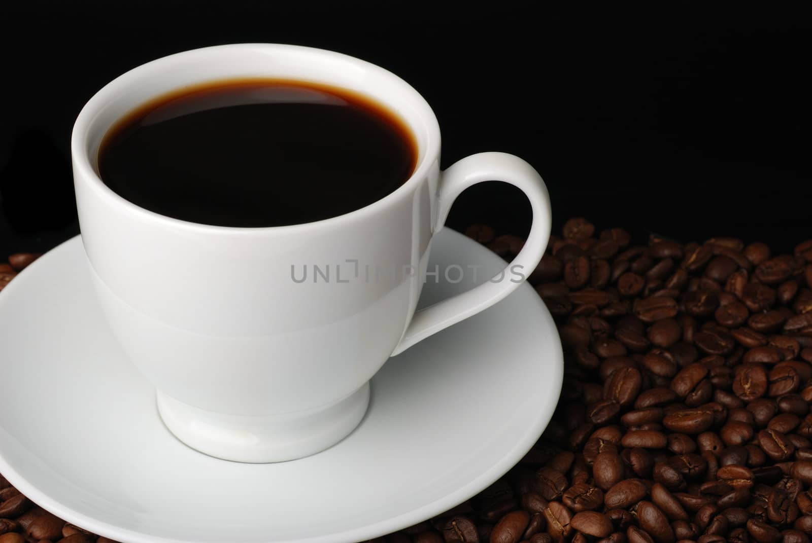 Cup of coffee. A background with coffee grains and a white cup. A photo close up 