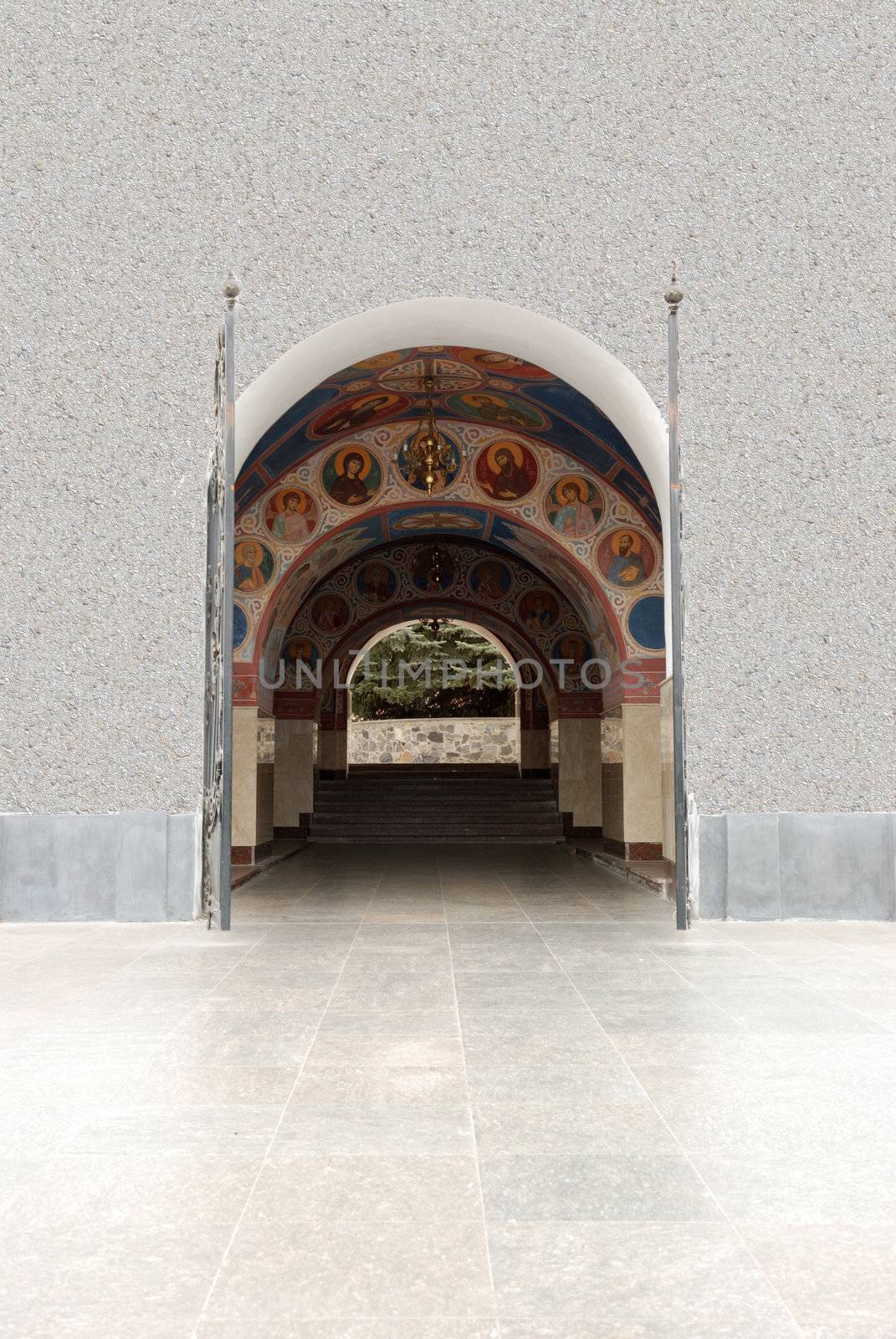 Arch gateway in church. The paved way to a white building