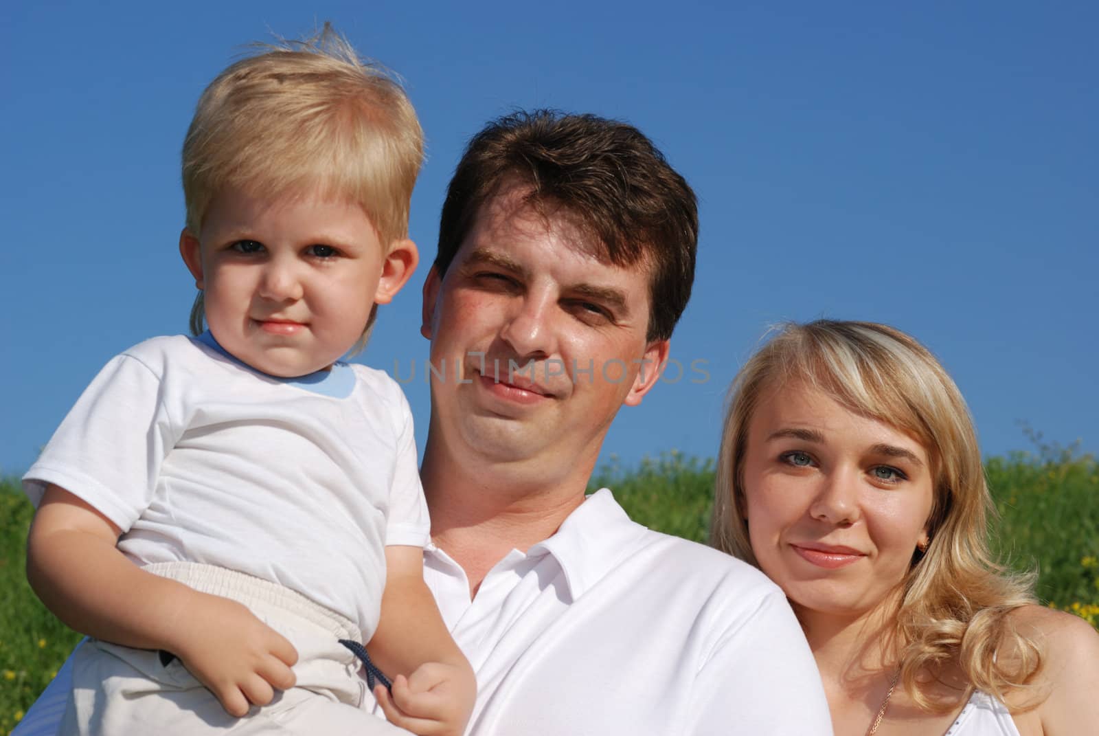 Family. The daddy, mum, the child. A photo on open air