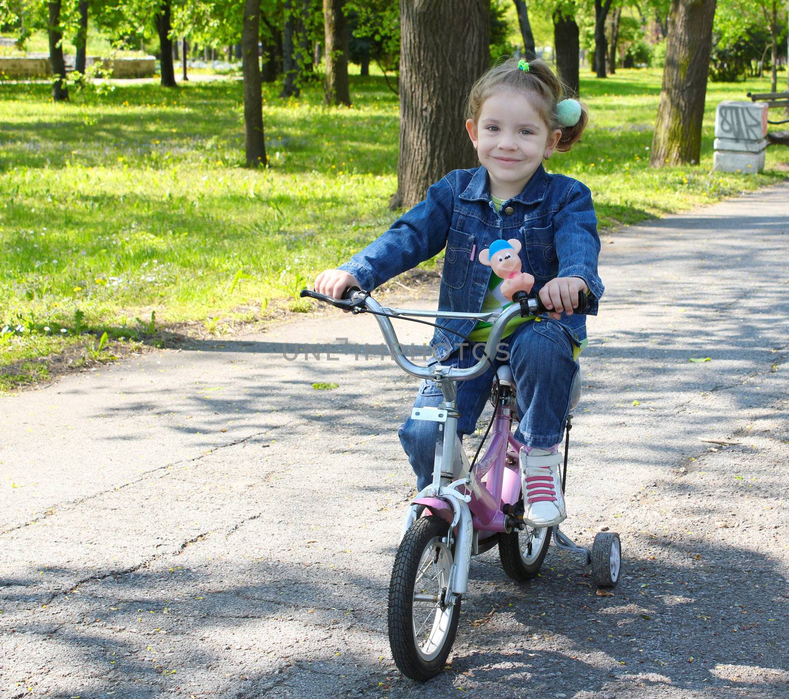 child riding bicycle in park by goce