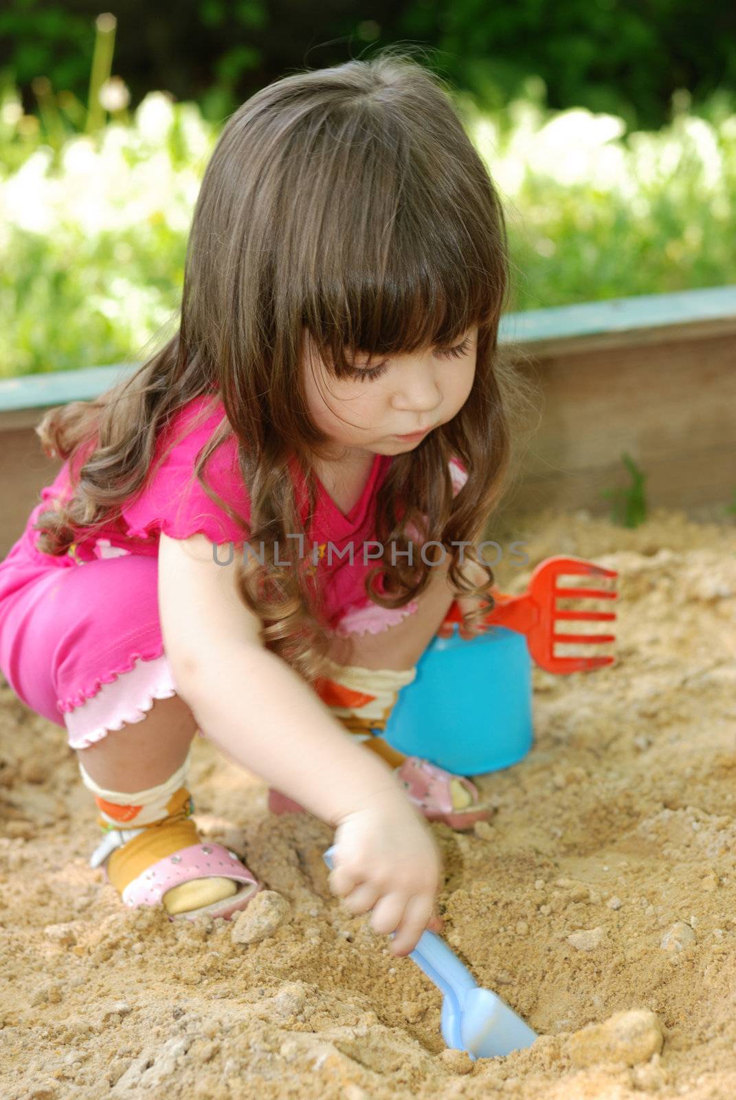 The girl playing to a sandbox by galdzer