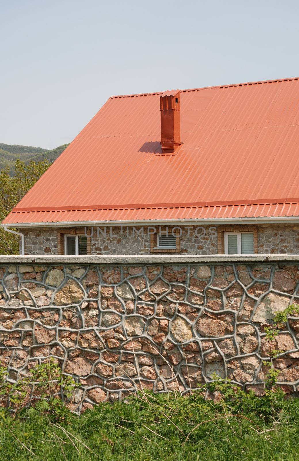 Red roof. A cottage constructed highly in mountains